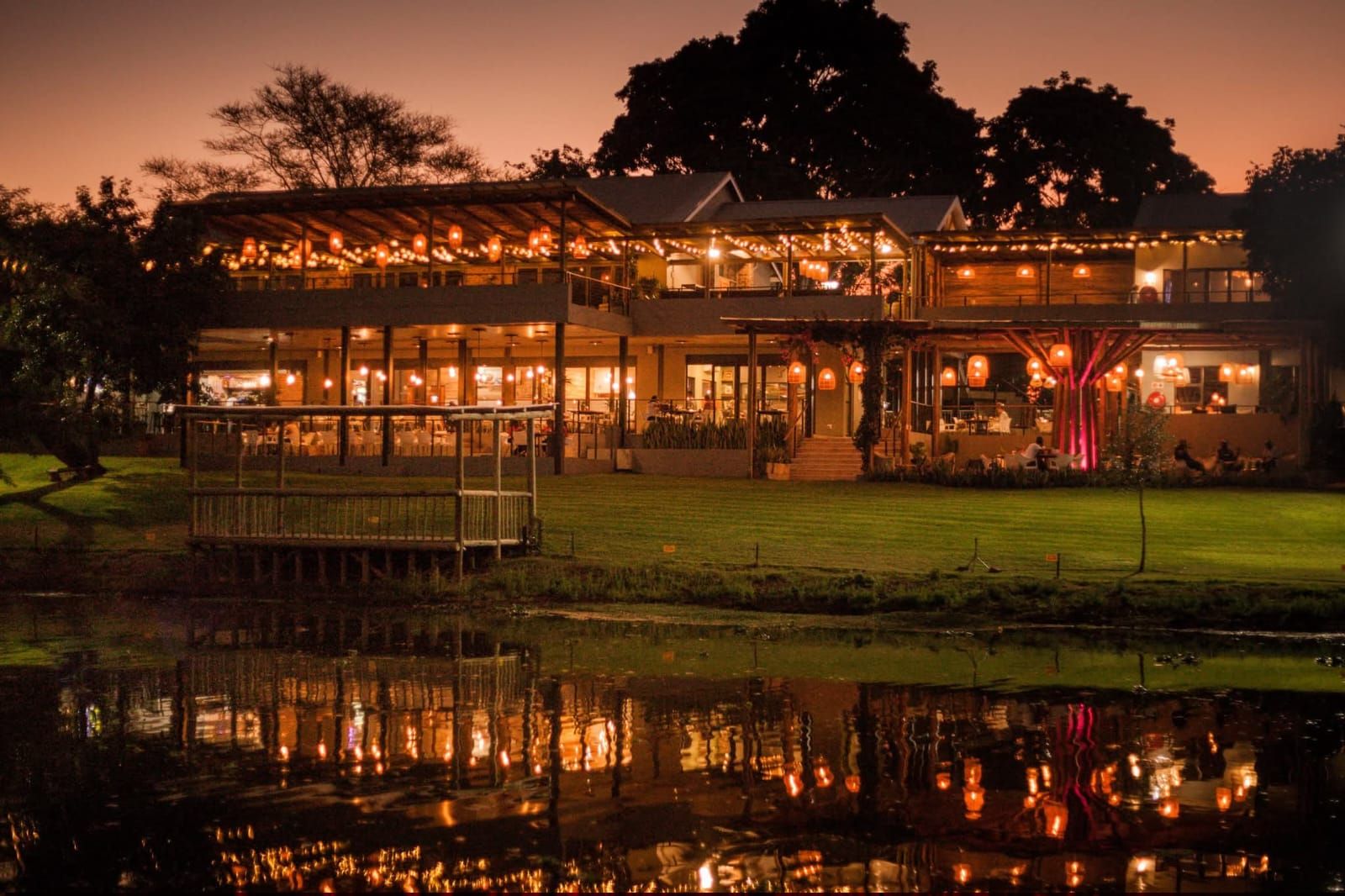 Lodge restaurant lit up at night across the water